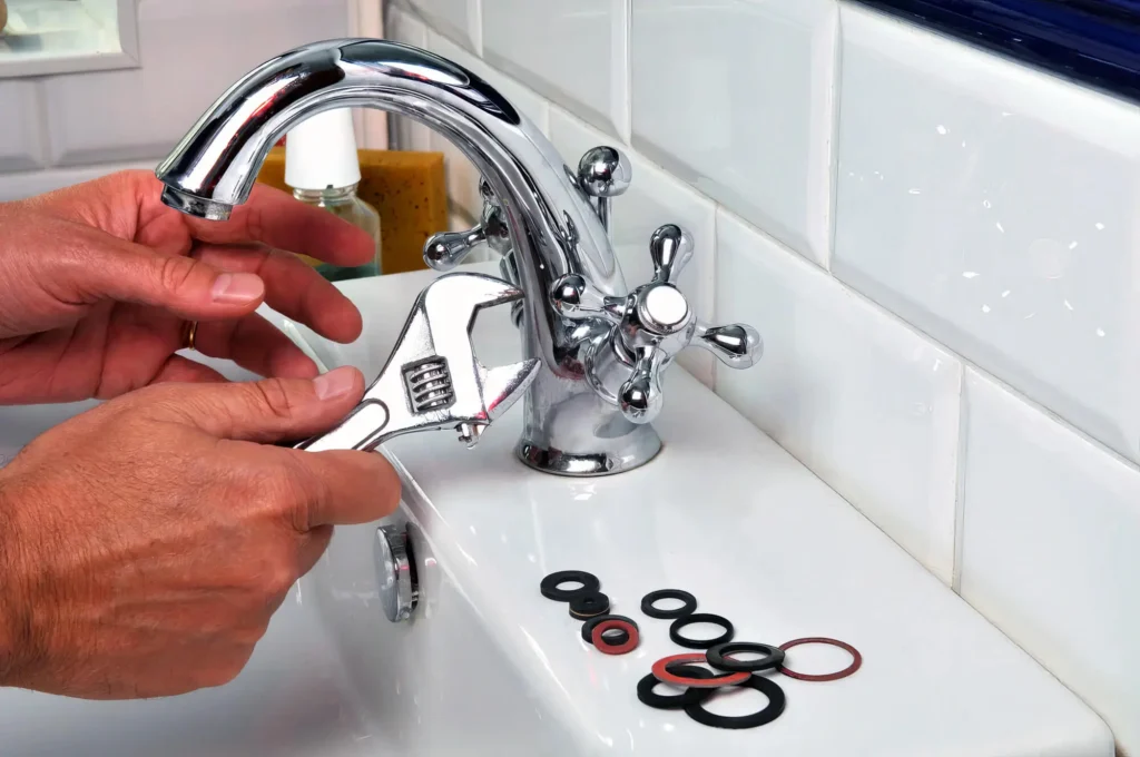 Plumber performing maintenance on a bathroom faucet in Prescott Valley