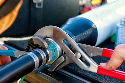 Technician tightening an industrial pipe connection in Prescott Valley